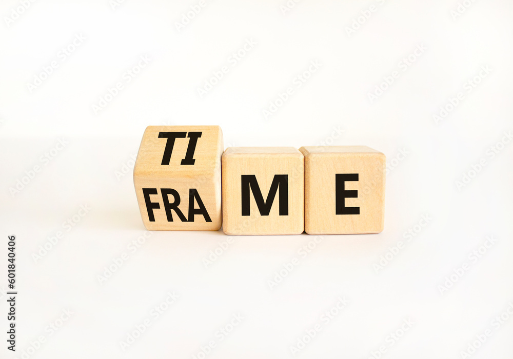 Time frame symbol. Businessman turns wooden cubes and change the concept word time to frame. Beautiful white table white background, copy space. Business and time frame concept. Time frame symbol. Businessman turns wooden cubes and change the concept word time to frame. Beautiful white table white background, copy space. Business and time frame concept.