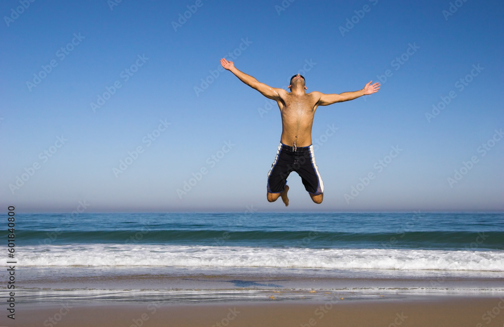 Man running and jumping on the beach