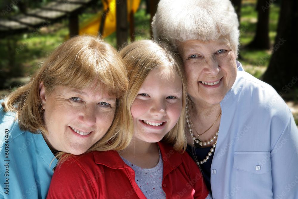 Fototapeta premium Three generations, a grandmother, mother, and daughter in the park.