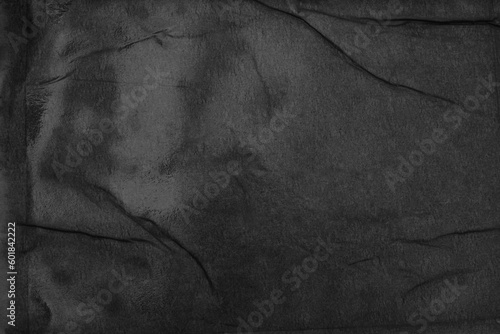 Empty black crumpled wet craft paper blank texture copy space wall background.
