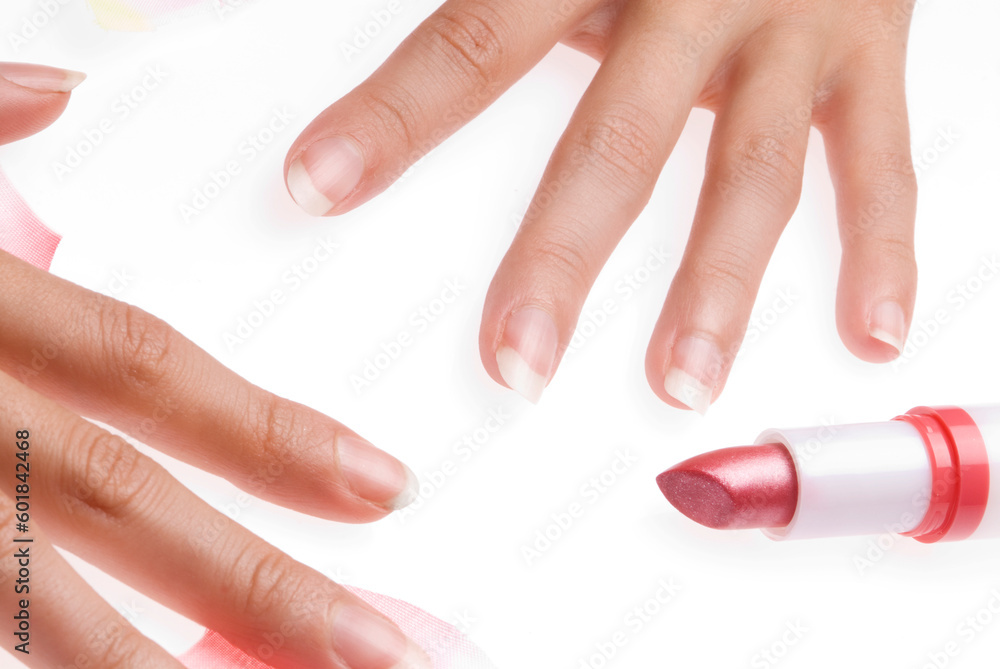 close up of woman hands with a red lipstick and pink petals of roses all around close up of woman hands with a red lipstick and pink petals of roses all around