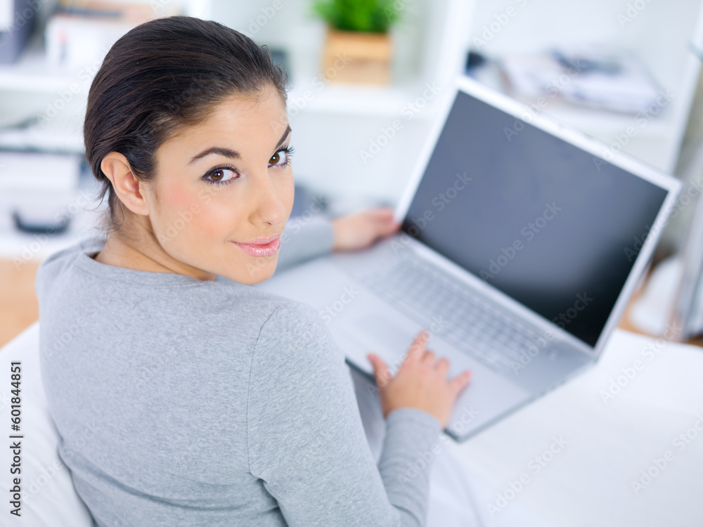 Young woman sitting on couch and working on laptop Young woman sitting on couch and working on laptop