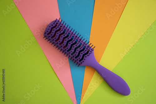Hairbrush on colored background