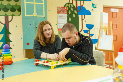 a psychologist is engaged with an autistic man with mental disabilities