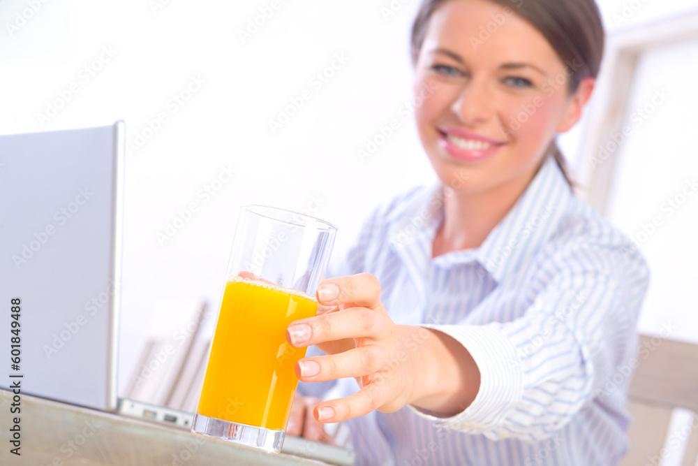 Beautiful woman reaching for glass of juice Beautiful woman reaching for glass of juice