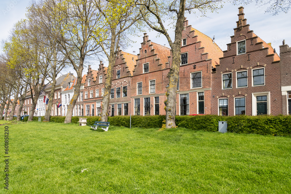 Historic houses with stepped gables along the harbor in Medemblik in West Friesland.