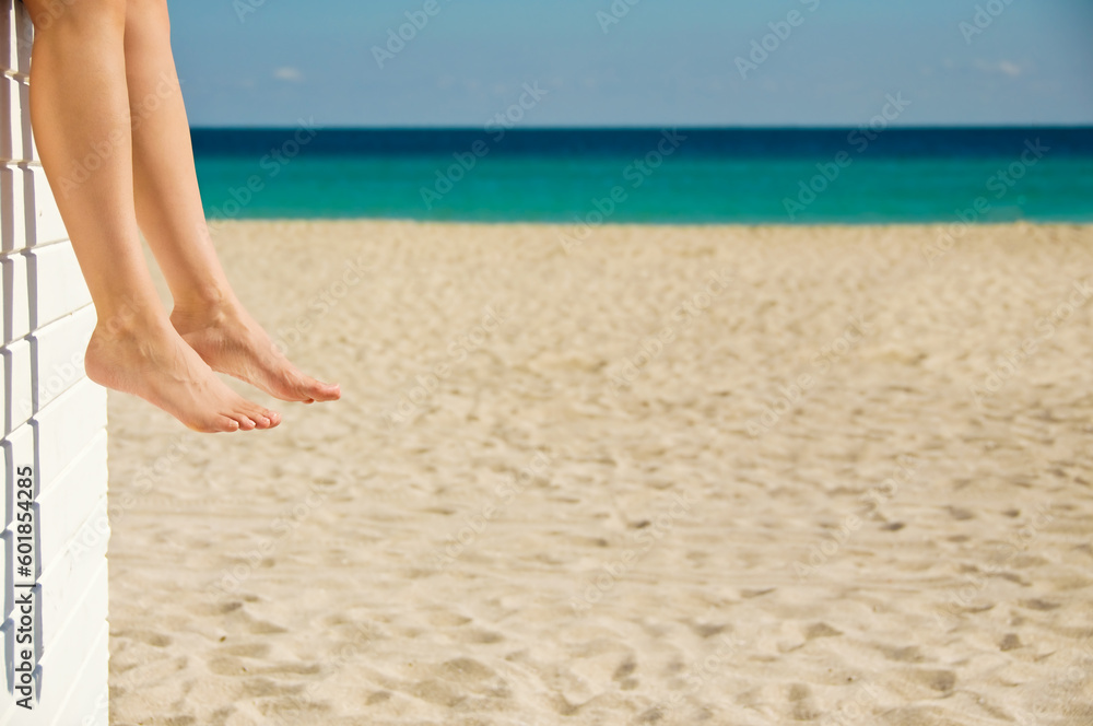 Woman relaxing on the beach on a sunny day Woman relaxing on the beach on a sunny day