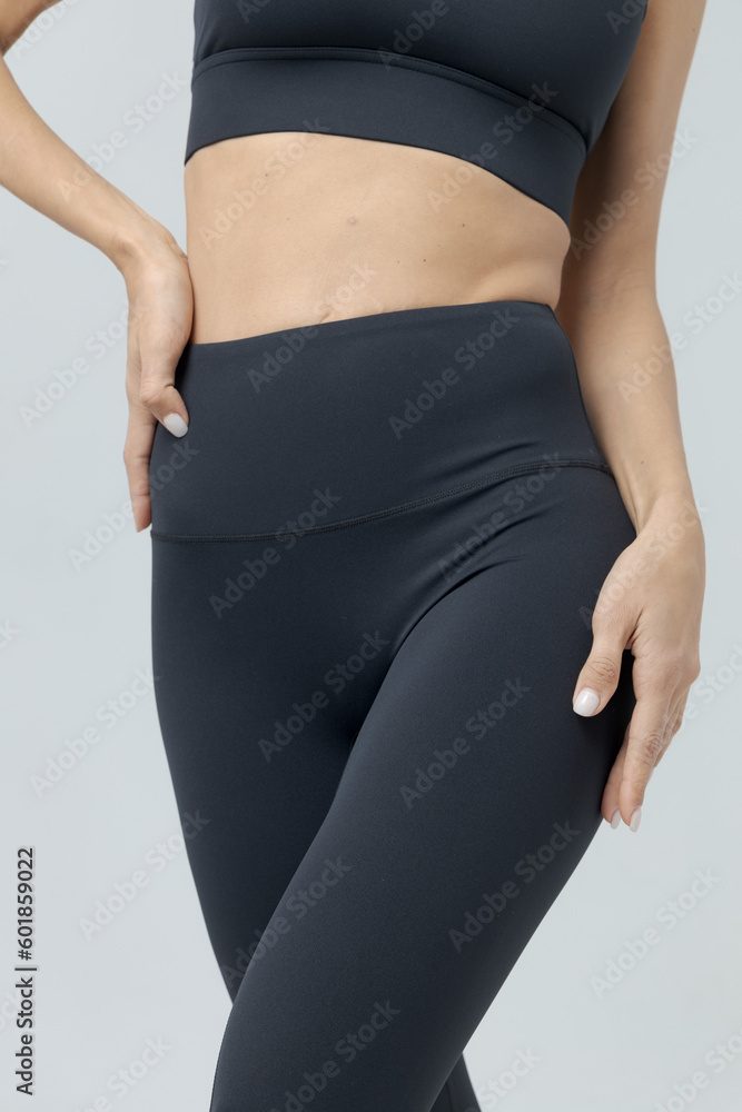 Fototapeta premium a girl in a black tracksuit on a white background