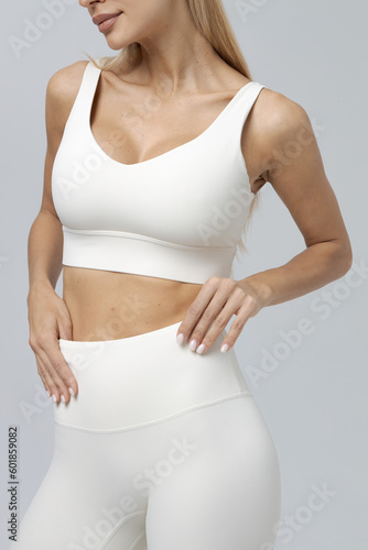 a girl in a white tracksuit on a white background