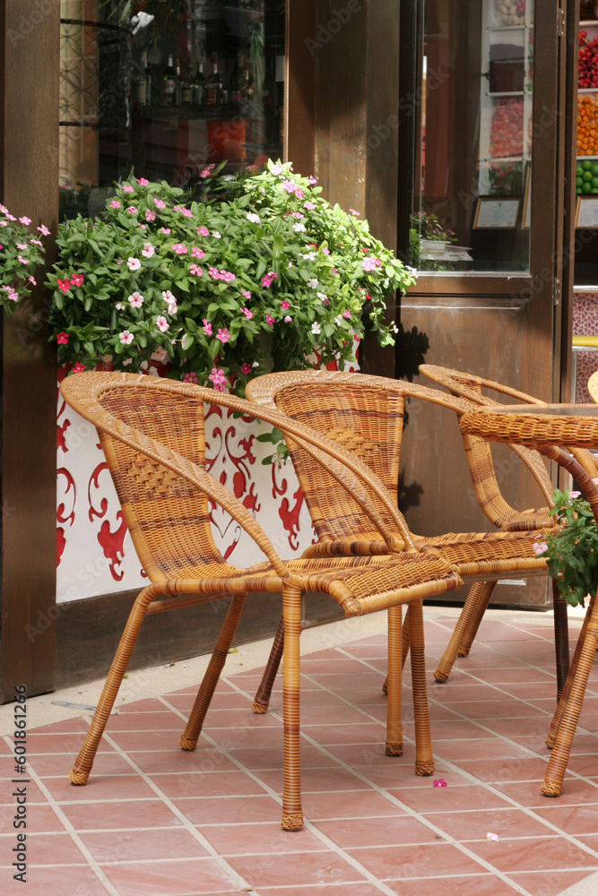 Cane chairs in an outdoor seating area.