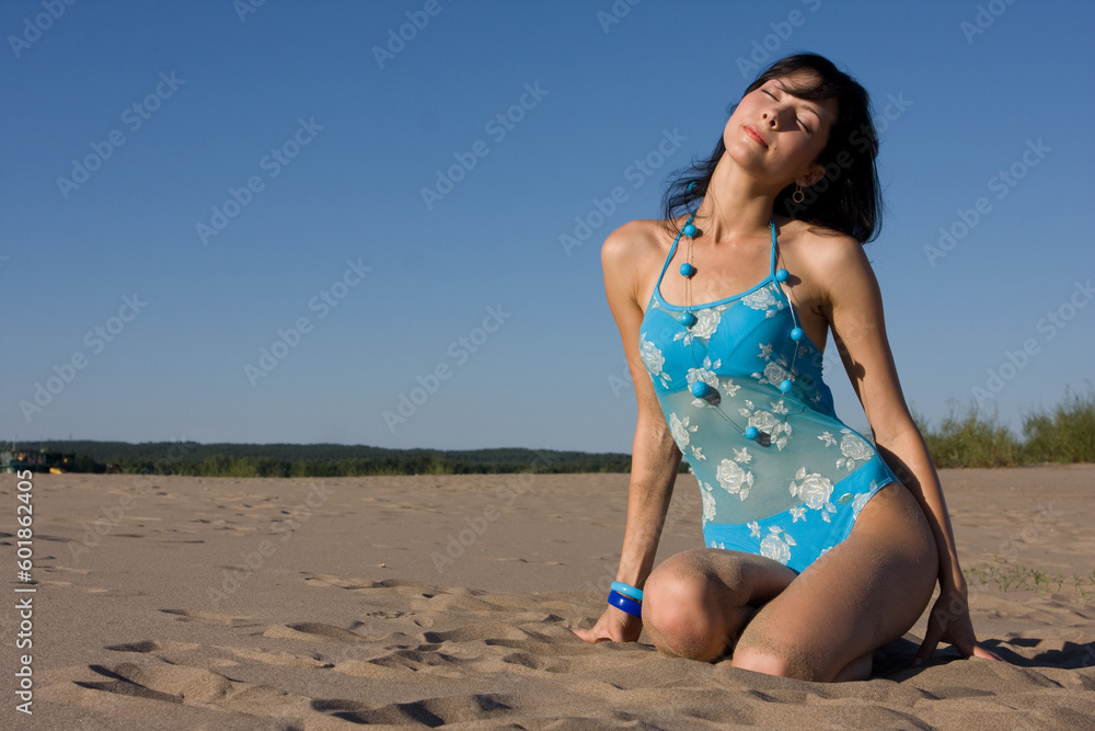 Beautiful girl in swimsuit relaxing on the beach Beautiful girl in swimsuit relaxing on the beach