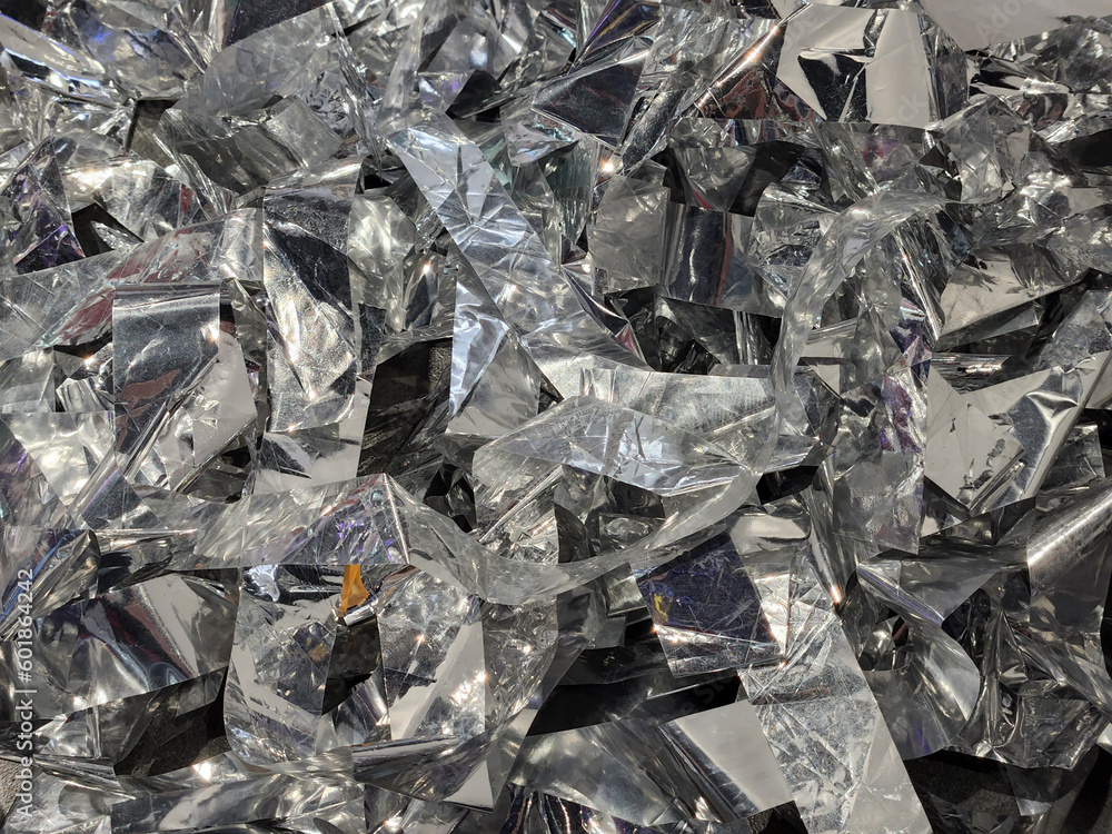 Foil tinsel. Silver foil sequins. Festive background Foil tinsel. Silver foil sequins. Festive background