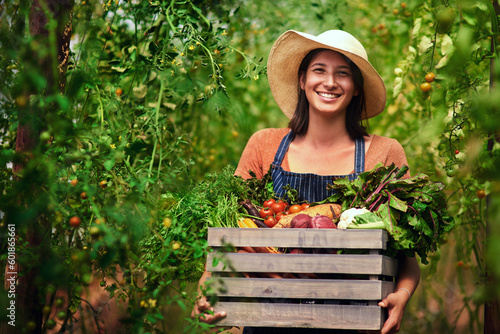Farmer, agriculture and portrait of woman with box on farm after harvest of summer vegetables. Farming, female person and smile with crate of green product, food and agro in nature for sustainability photo