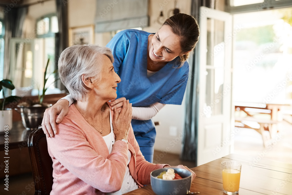 Healthcare, elderly woman with nurse with breakfast at her home and at the table in living room. Support or communication, caregiver and conversation with medical person with senior or old female. - obrazy, fototapety, plakaty 
