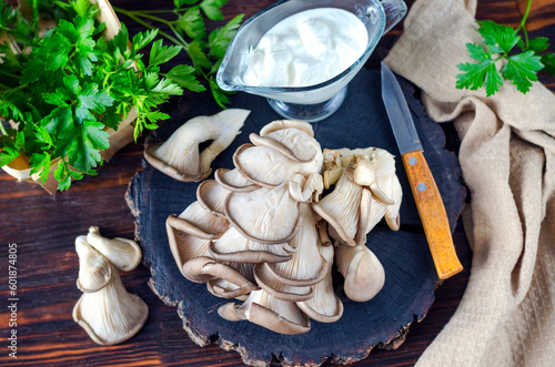 Fresh oyster mushrooms on a wooden board on the table