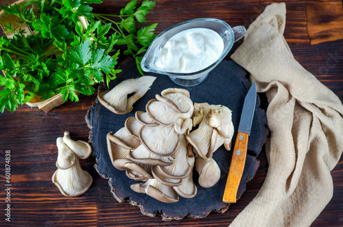 Fresh oyster mushrooms on a wooden board on the table
