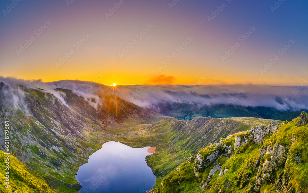 Amazing sunrise above misty mountains from Cadair Idris, Snowdonia, North Wales