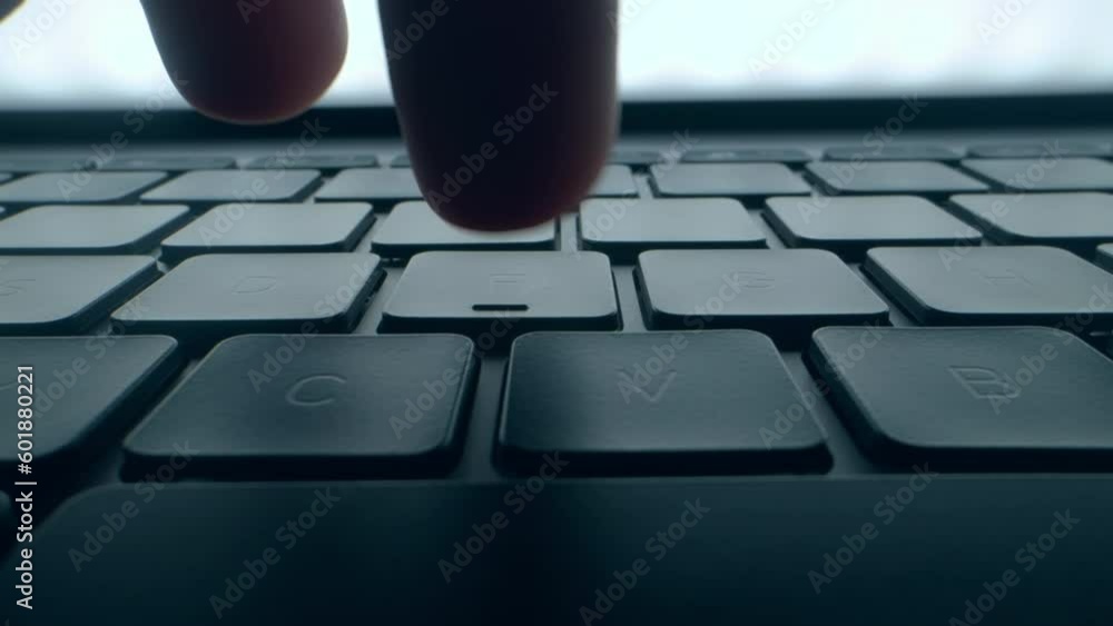 A program coder is typing on laptop keyboard close up macro. Hacker is using computer. Man hands are searching in web or working on pc. Concept of digital cyber security and vpn data protection