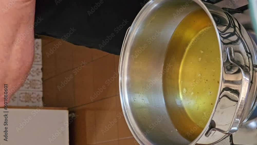 Frying the raincake, typical food in Brazil, fried dough in oil, 4k, vertical video, selective focus. Frying the raincake, typical food in Brazil, fried dough in oil, 4k, vertical video, selective focus.