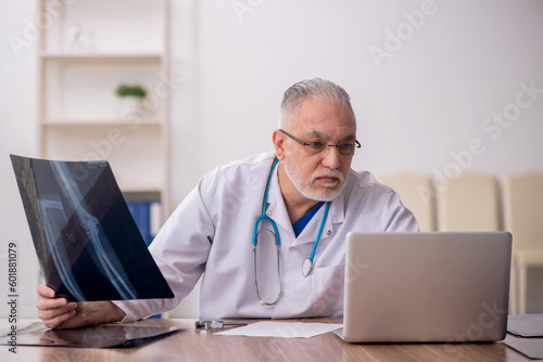 Old male doctor radiologist working in the clinic