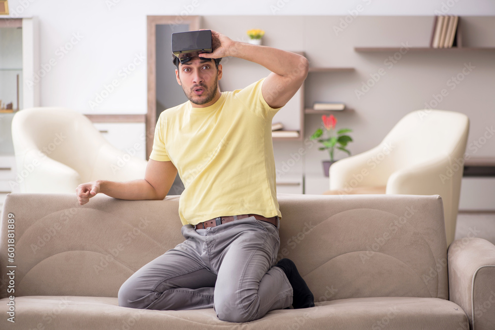Young man enjoying virtual glasses at home Young man enjoying virtual glasses at home