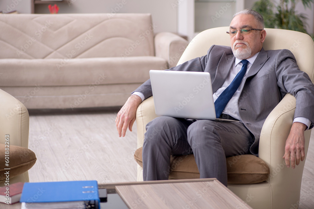 Old male boss working from home during pandemic Old male boss working from home during pandemic