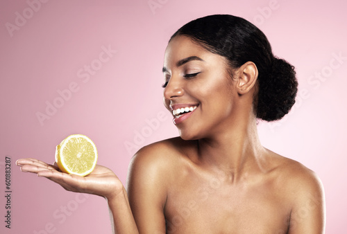Lemon, healthy beauty and happy woman in studio mockup, pink background and smile for vitamin c benefits. African model, citrus fruits and natural skincare for cosmetics, vegan dermatology and detox