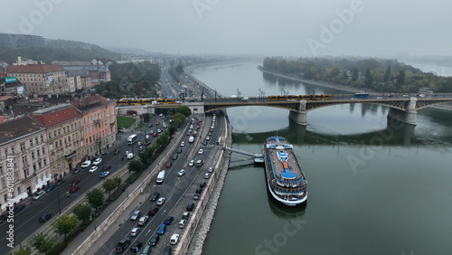 Aerial view of Budapest Margaret Bridge or Margit hid over River Danube, embankment. Yellow tram passing through the bridge