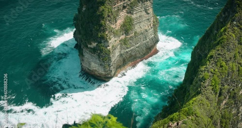 Green cape on tropical pristine island Nusa Penida - Kelingking beach with turquoise ocean in Indonesia. Paluang cliff. photo