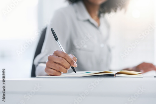 Pen, hand and writing in notebook or planning, working and office or journal, book or notes, record or research. Person, write and closeup on work, schedule or professional reminder and paper