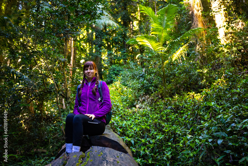 backpacker girl enjoys the scenery of unique gondwana rainforest, lamington national park in queensland, australia; bushwalking in australian rainforest photo