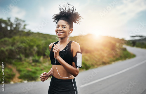 Bild auf Leinwand Sports, portrait and happy woman running in road with music earphones, workout or cardio routine