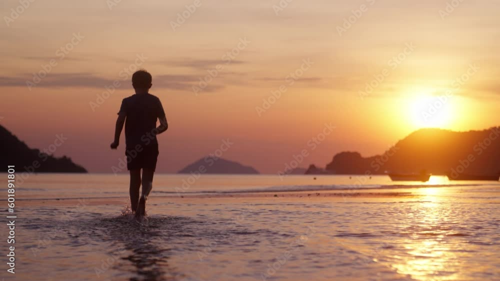 Boy Running Slowly In The Shallow Sea Water Boy Running Slowly In The Shallow Sea Water