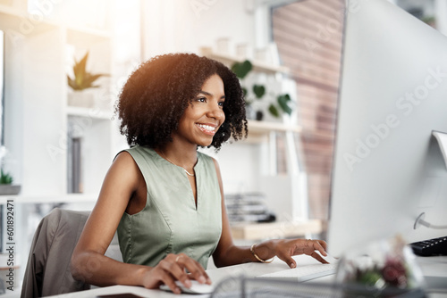 Business, computer and happy woman in office for research, planning and satisfied with web search. Online, review and African female person smile for report, proposal or creative design inspiration