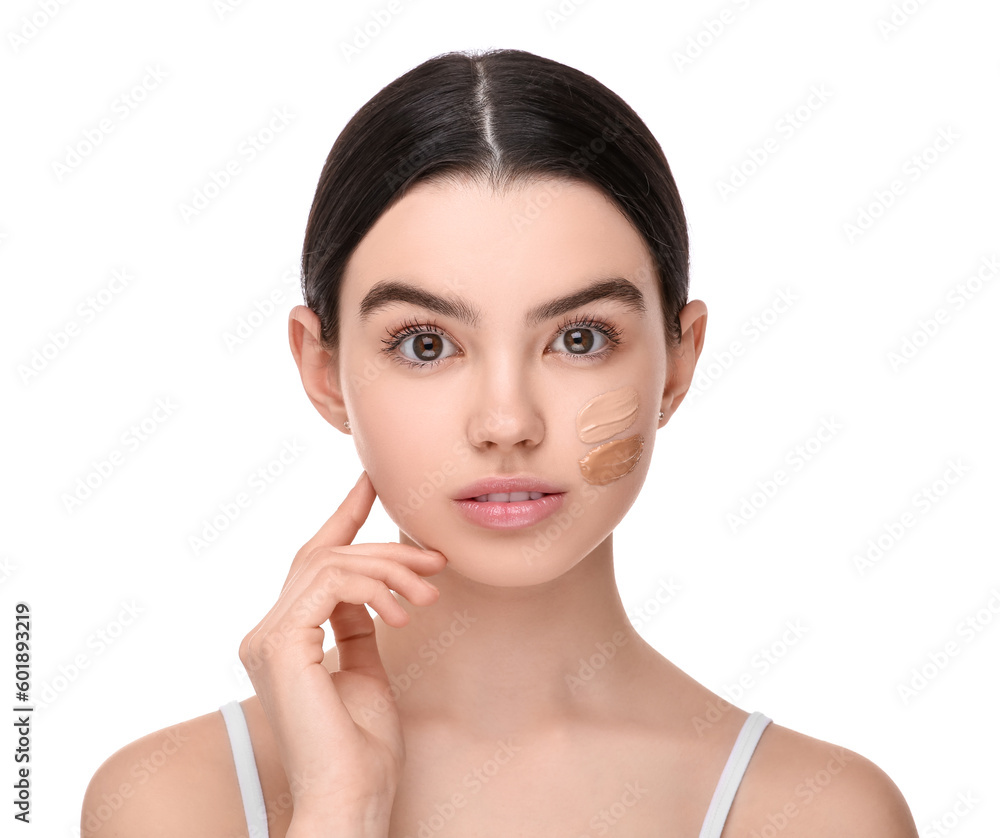 Teenage girl with swatches of foundation on face against white background Teenage girl with swatches of foundation on face against white background