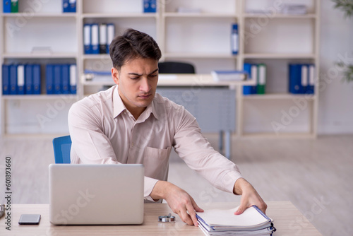 Young male employee working in the office