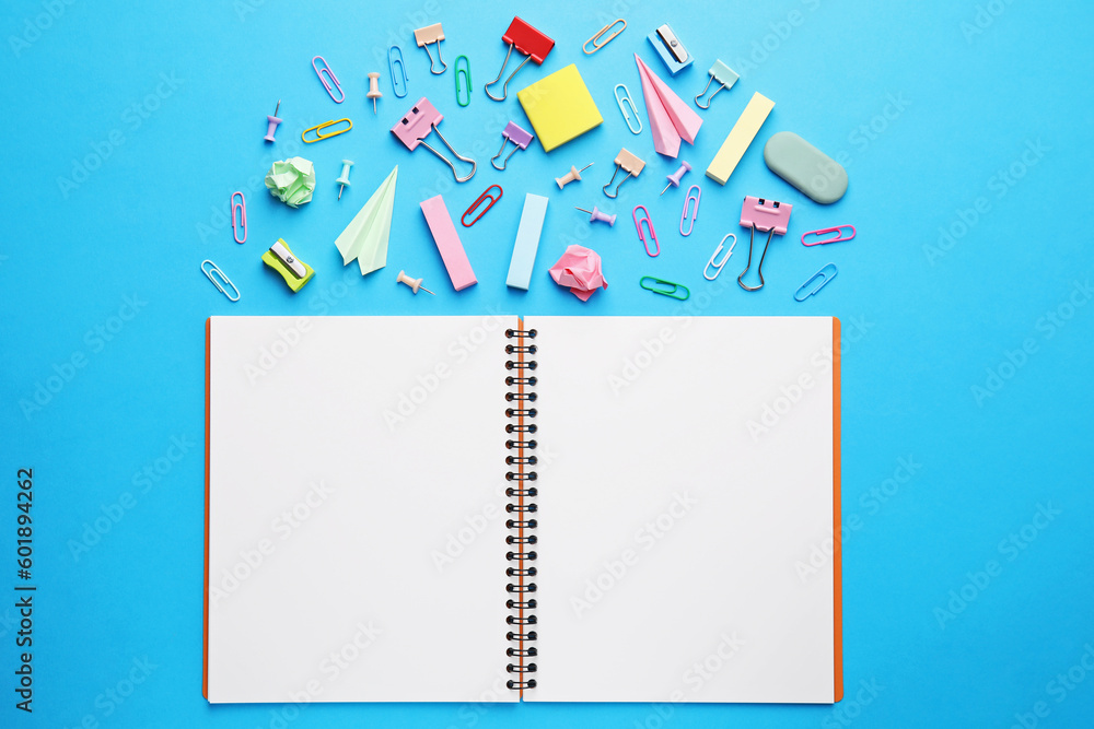 Back to school. School stationery and paper planes near notebook on light blue background, flat lay Back to school. School stationery and paper planes near notebook on light blue background, flat lay