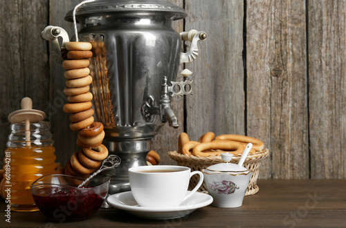 Composition with hot tea and delicious ring shaped Sushki (dry bagels) on wooden table, space for text photo