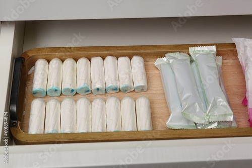 Storage of many different tampons in white drawer. Menstrual hygienic product