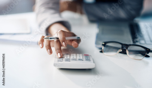 Calculator, accountant and woman working on financial investment report in the office. Accounting, taxes and closeup of female finance advisor doing calculation for asset management in the workplace.