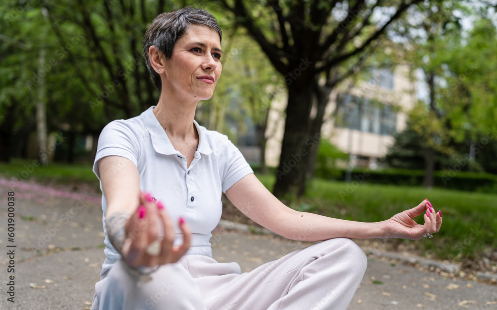 one mature woman senior female meditate alone in park in day one mature woman senior female meditate alone in park in day
