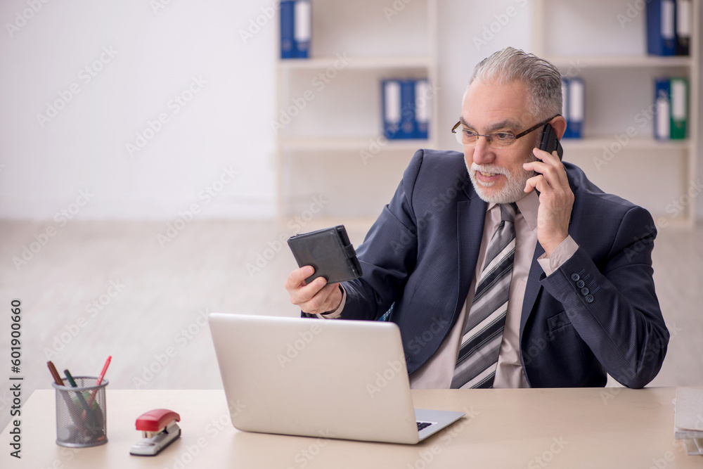 Old male employee in planning retirement concept Old male employee in planning retirement concept