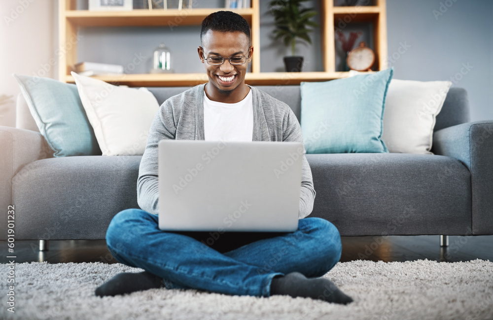 Laptop, floor and happy man with work from home, online research and typing in living room for career opportunity. Relax, carpet and young african person working on computer or technology in lounge Laptop, floor and happy man with work from home, online research and typing in living room for career opportunity. Relax, carpet and young african person working on computer or technology in lounge