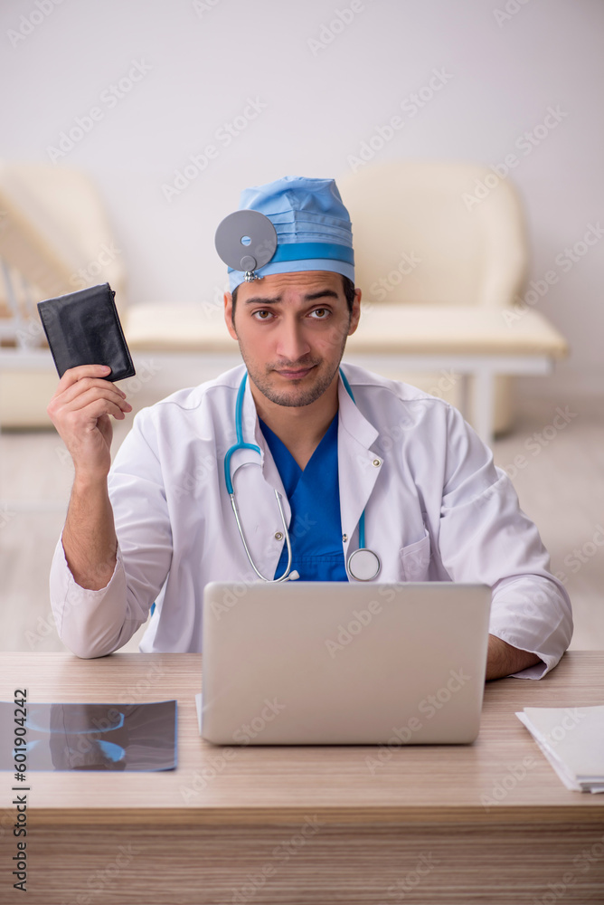 Young male doctor otologist working in the clinic Young male doctor otologist working in the clinic