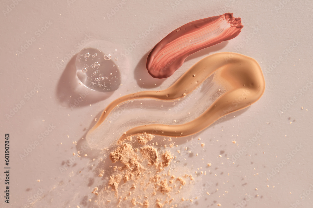 Obraz premium A sample of red lip gloss, foundation, powder and gel makeup base.