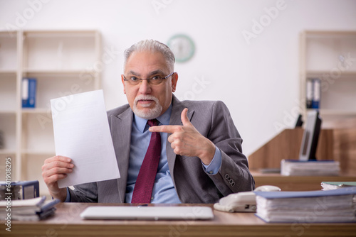 Wallpaper Mural Old male boss employee working in the office Torontodigital.ca