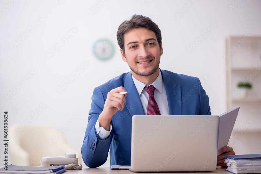 Young male employee working in the office Young male employee working in the office