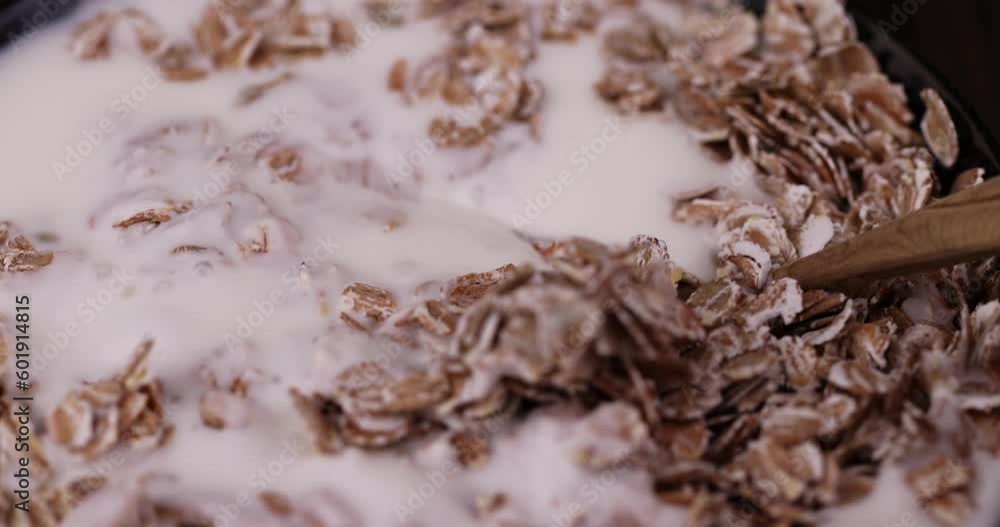 spoon in yogurt made from cow's milk with the addition of a large amount of oat flakes, a quick breakfast of oat flakes and dairy products spoon in yogurt made from cow's milk with the addition of a large amount of oat flakes, a quick breakfast of oat flakes and dairy products