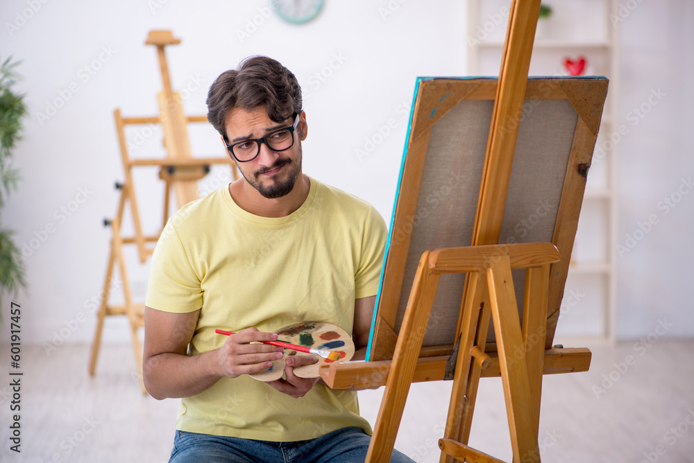 Young man enjoying painting at home Young man enjoying painting at home
