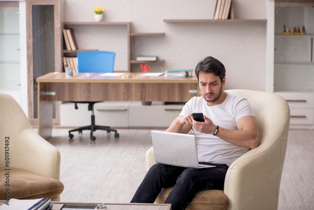 Young male employee working from home during pandemic Young male employee working from home during pandemic